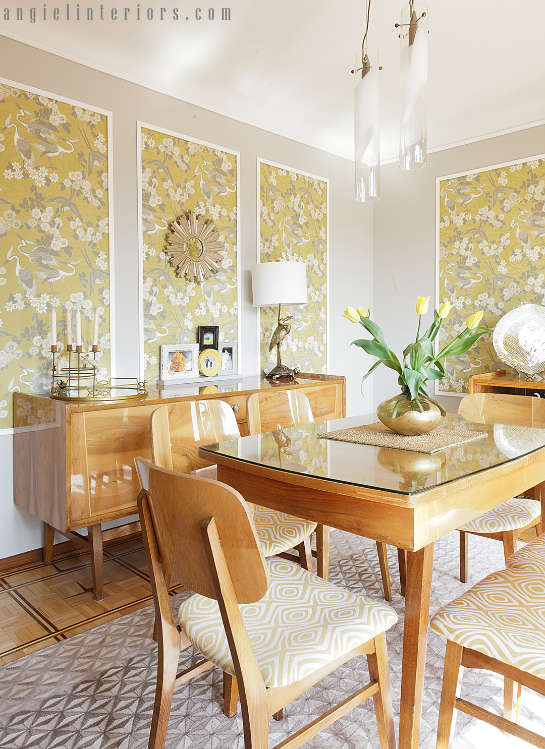 GR&J Baker Heron wallpaper in yellow and grey dining room with Mid-century modern dining set and brass accents