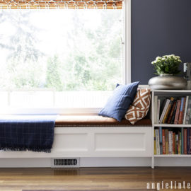 Custom window bench with storage and upholstered top and bookcase
