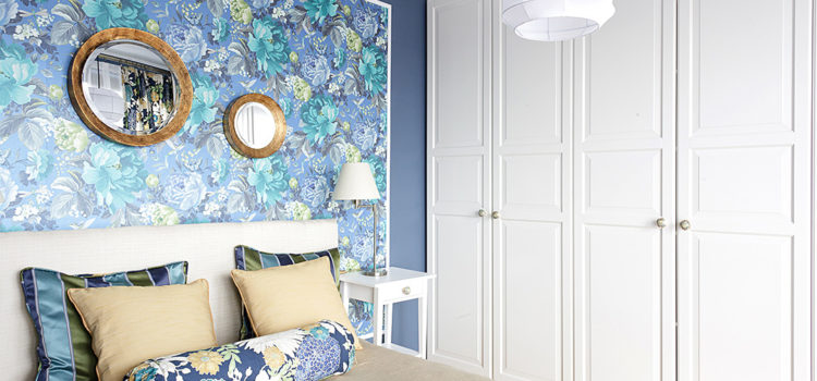 Ikea closet and bed. Richloom St.Moritz floral fabric and A Shade Wilder Dianthus wallpaper in blue and white bedroom with gold accents
