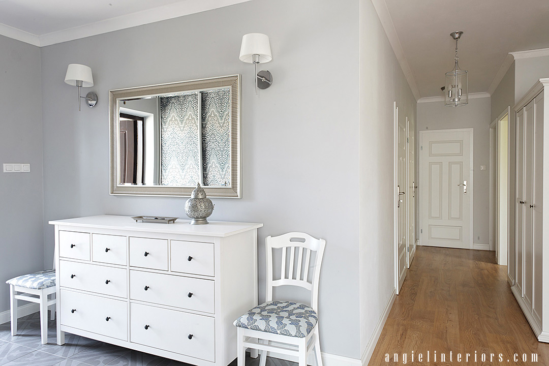 bright grey and white entry with Ikea Hemnes dresser, silver mirrors, sconces and wallpaper on closet doors