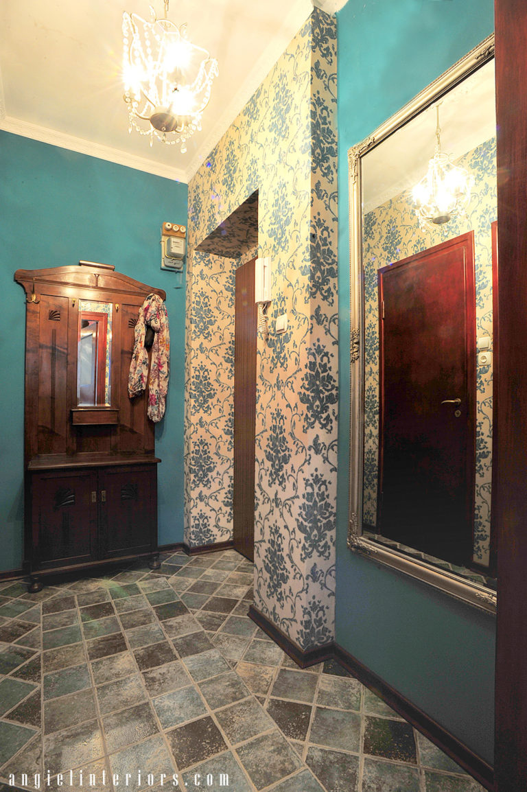 Teal damask wallpaper. walls and floor tiles in a small entry with antique hall tree