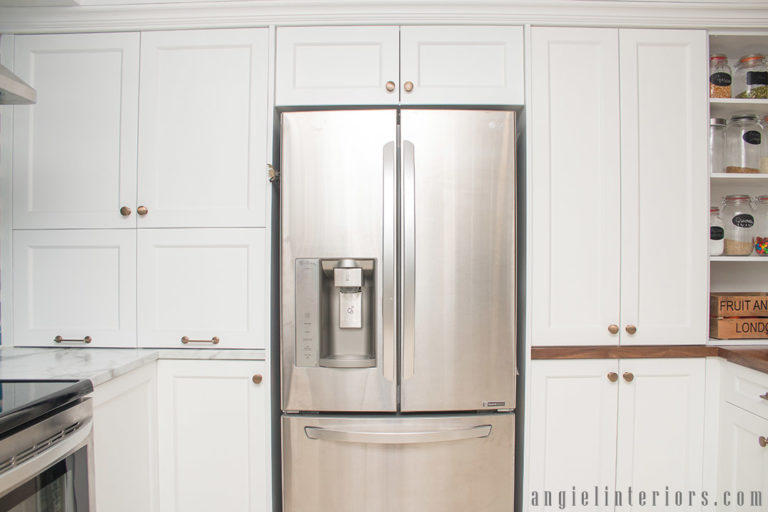 White shaker cabinets with champagne gold hardware in contemporary kitchen