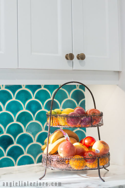 White shaker cabinets with turquoise ceramic tiles backsplash and champagne gold hardware