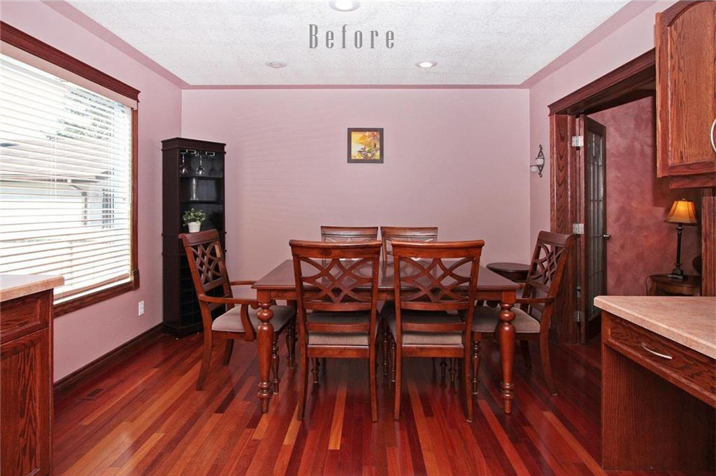 Dining area with pink walls and dark woodwork