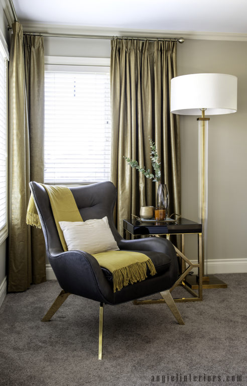 master bedroom decor details: leather armchair, gold floor lamp, gold and black side table