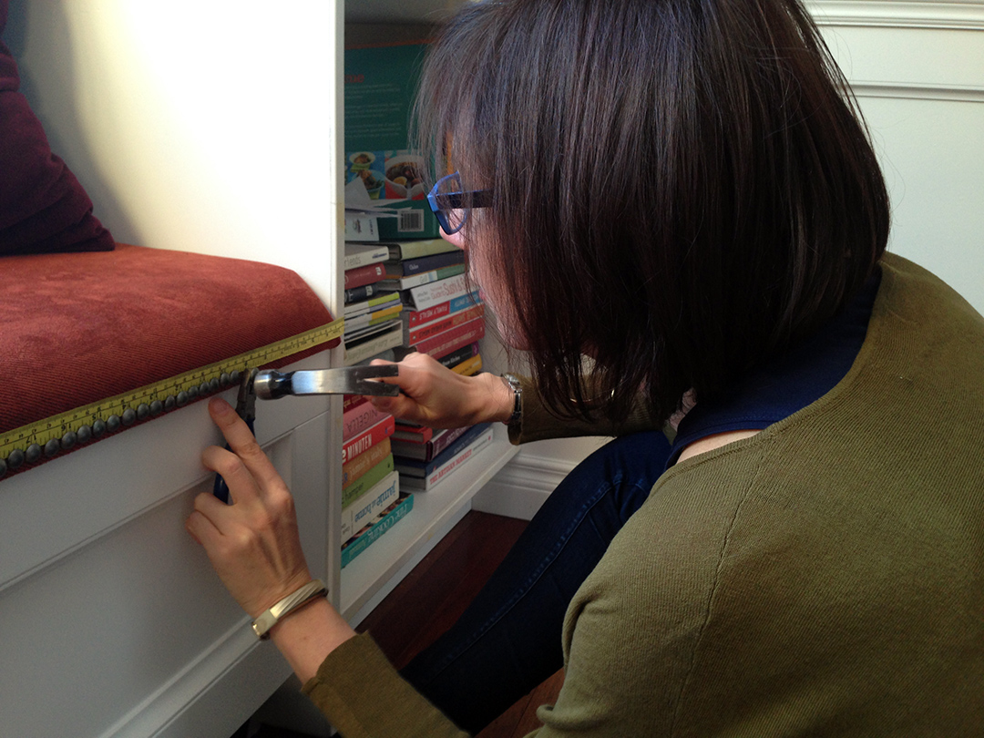 upholstered custom window bench with decorative nails