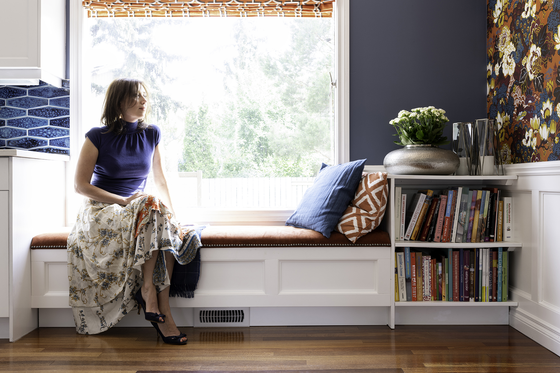 Upholstered window bench with storage and bookcase, roman shades and cushions