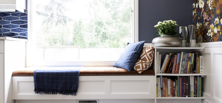 Custom window bench with storage and upholstered top and bookcase