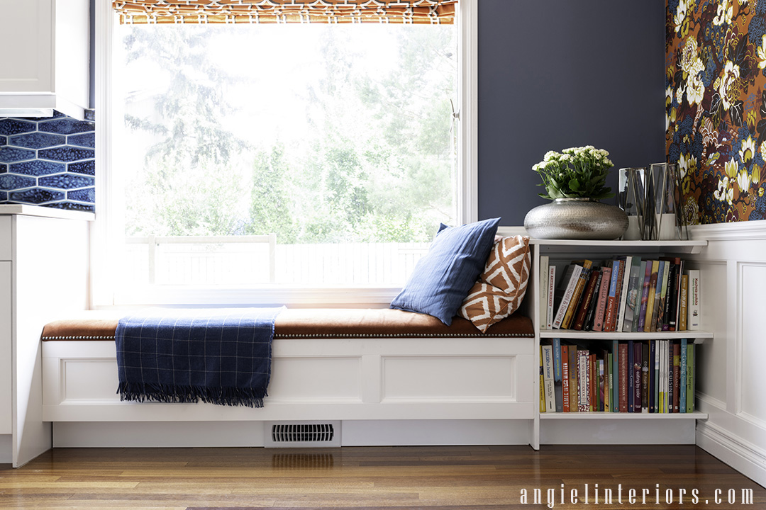 Custom window bench with storage and upholstered top and bookcase