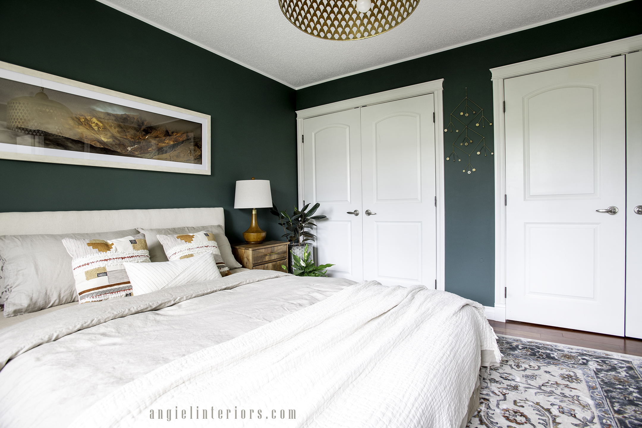 bedroom with dark green walls and wooden details