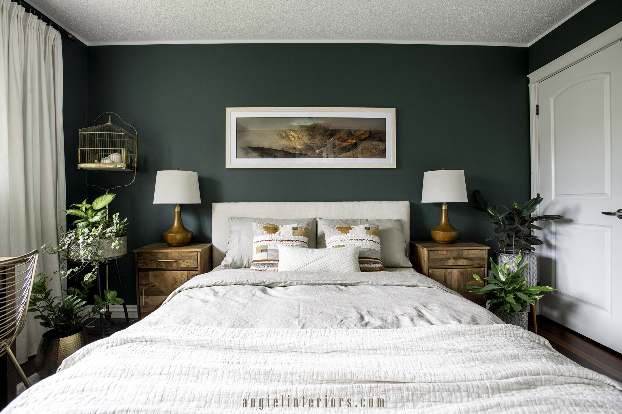 bedroom with dark green walls and bohemian decor with plants