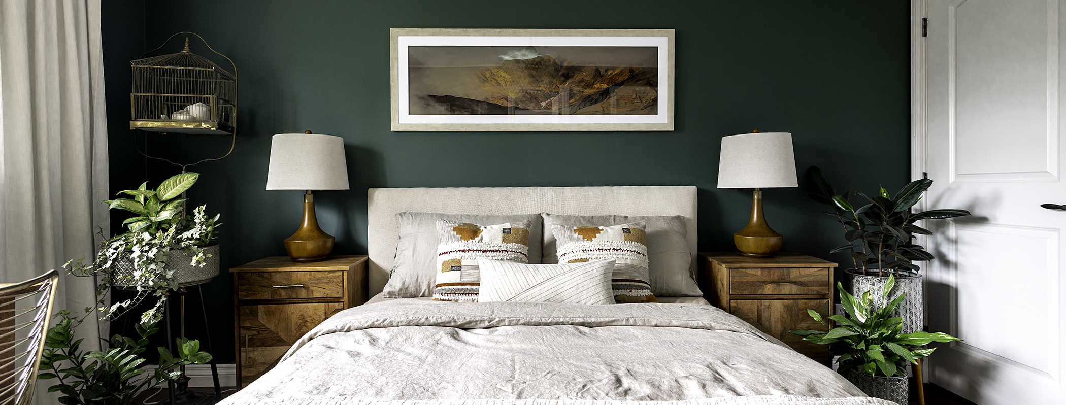 dark green bedroom with wood and brass decor