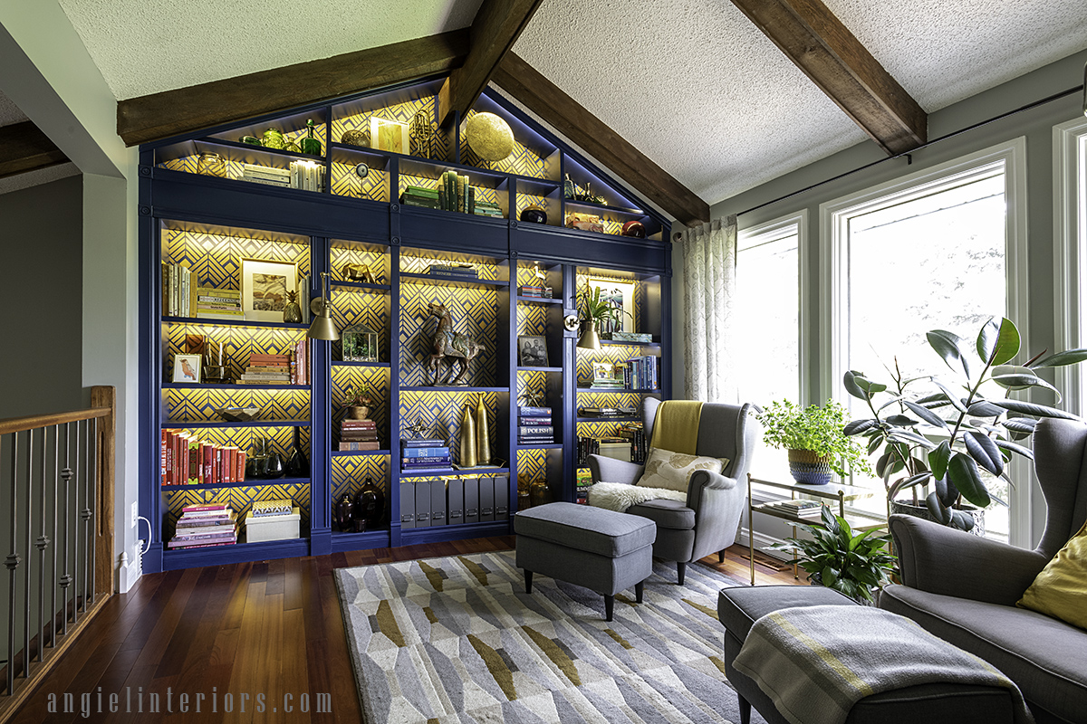 Home library with built in IKEA hacked bookcase under vaulted ceiling